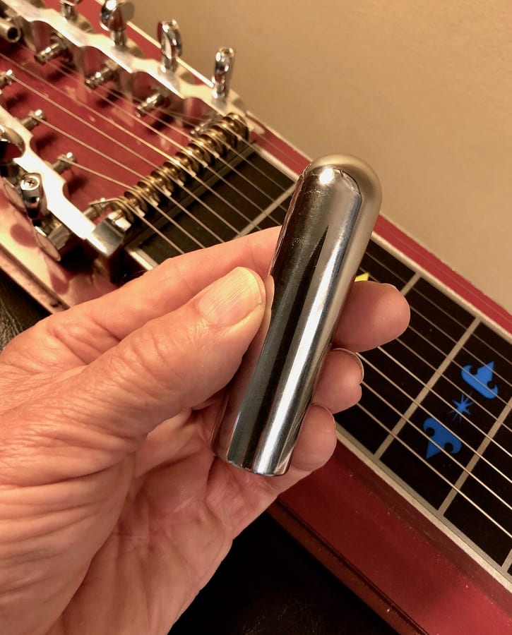 Close-up photograph of a steel guitar tonebar.