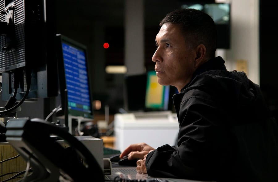 Photograph of a technician monitoring tracking data.